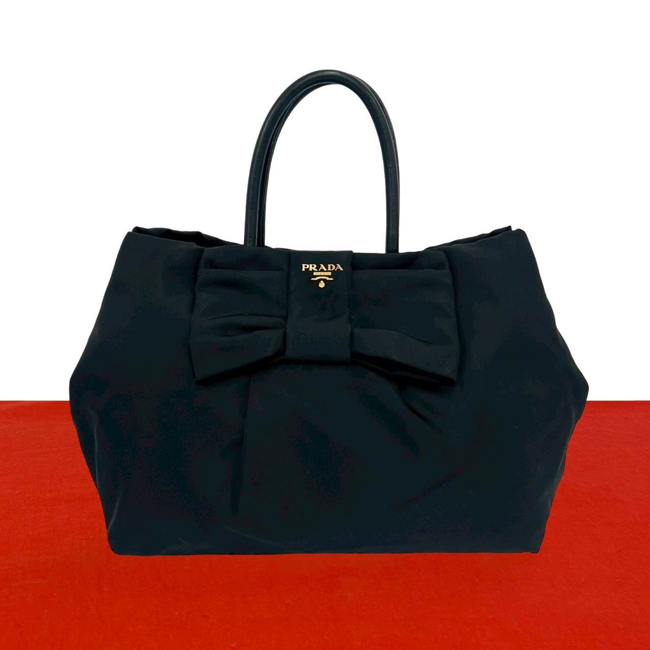 PRADA プラダ ロゴ 金具 リボン モチーフ ナイロン レザー ハンドバッグ ブラック
 037-1