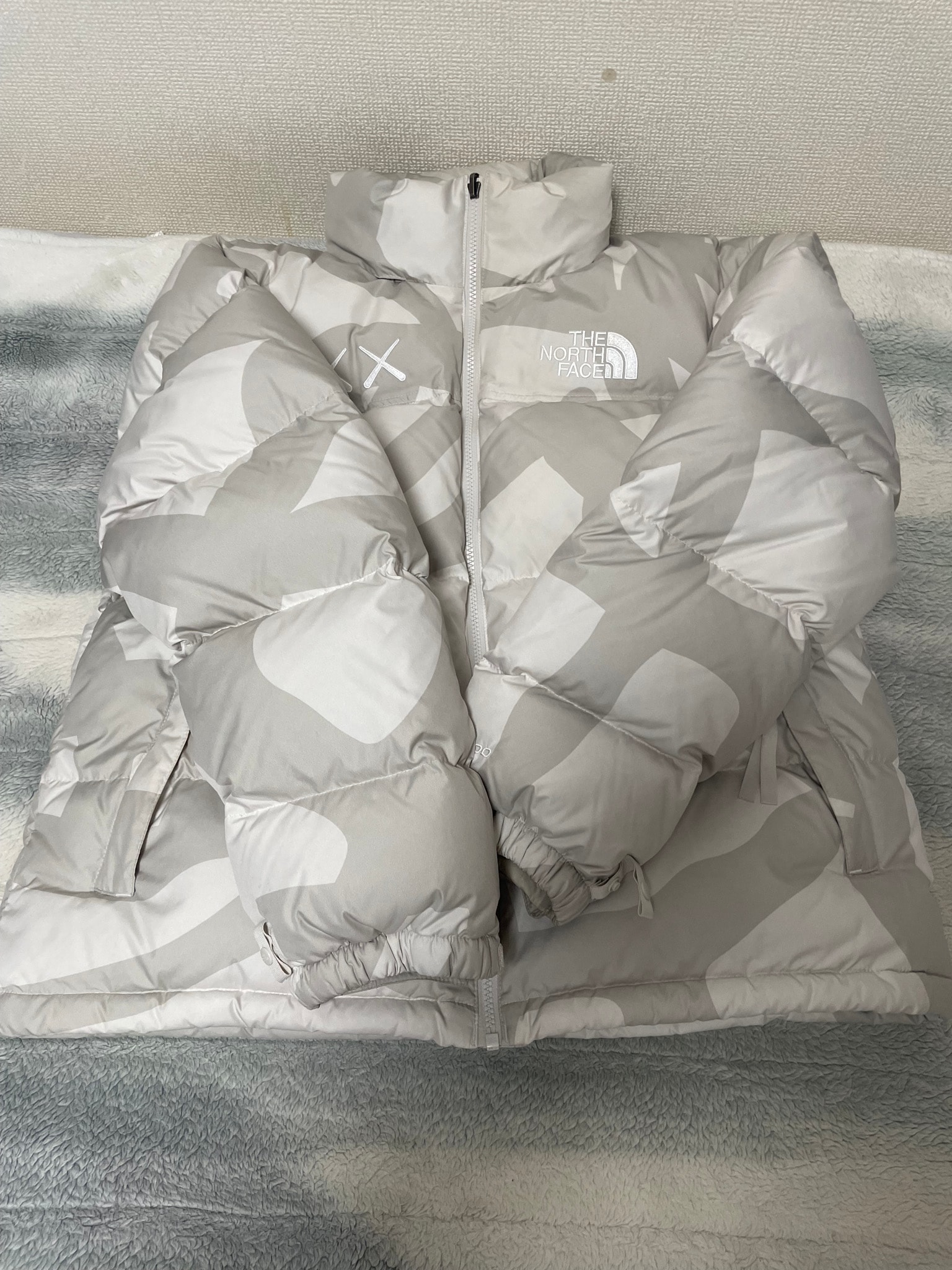The North Face x Kaws Retro 1996 Nuptse Jacket "Moonlight Ivory"