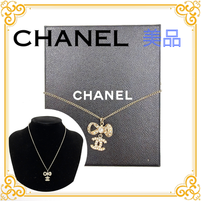 CHANEL Coco Mark Rhinestone Ribbon Necklace "Gold"