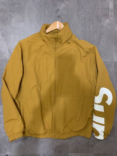 Supreme Spellout Track Jacket "Dark Gold"