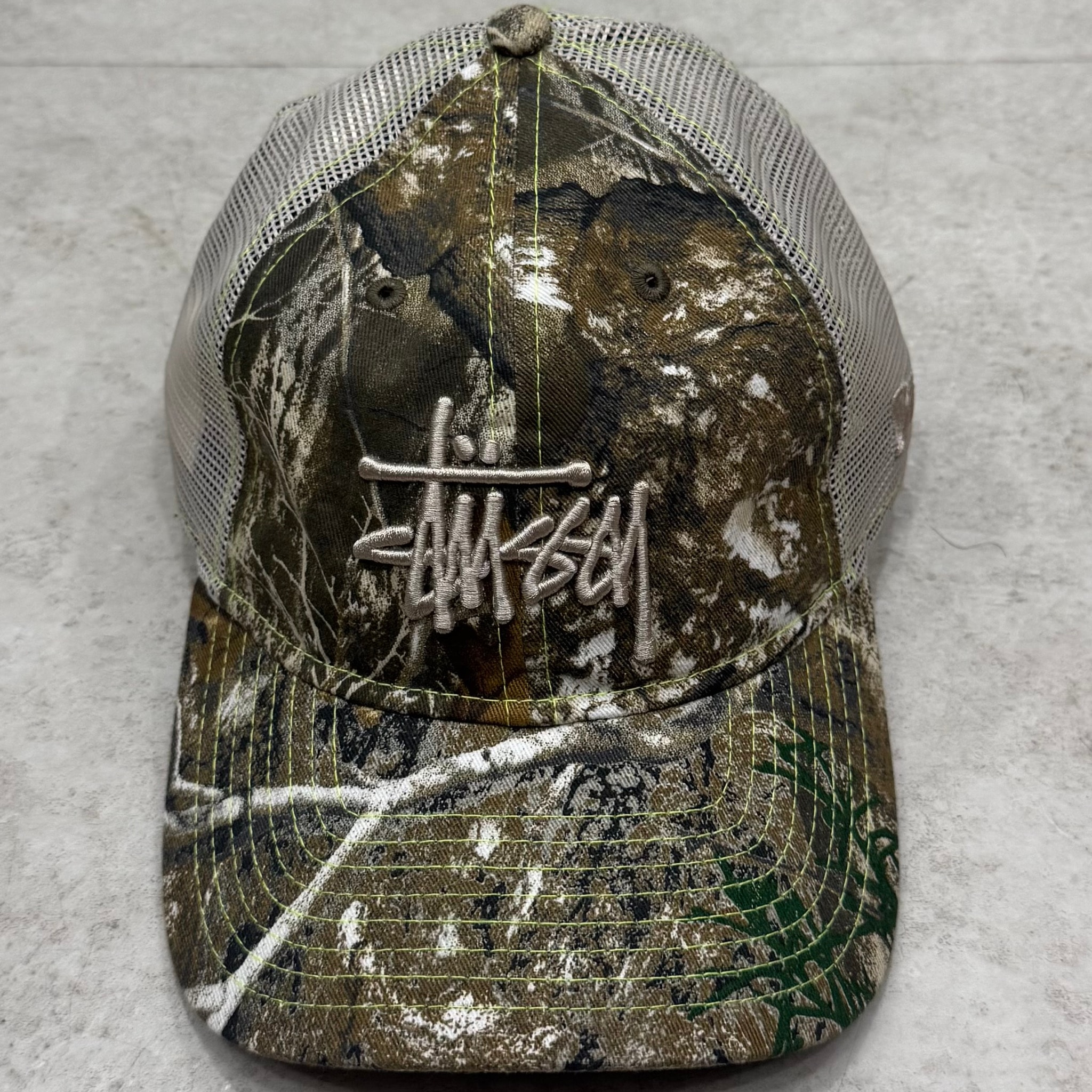 Stussy New Era 9Twenty Washed Basic Trucker "Real Tree Edge"