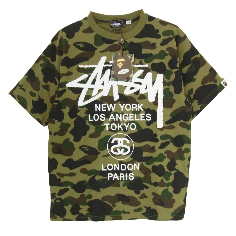 A BATHING APE アベイシングエイプ Tシャツ × STUSSY ステューシー 30周年記念 ワールドツアー ロゴ カモ柄 半袖 カットソー Tシャツ カーキ系 M【新古品】【未使用】【中古】