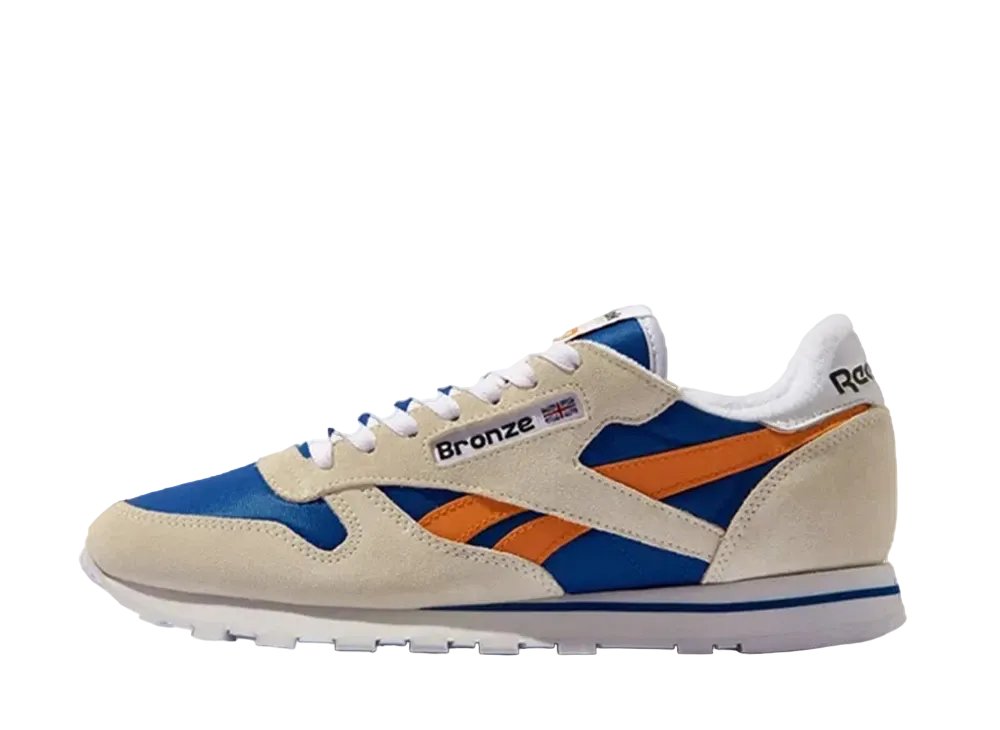 ブロンズ 56K × リーボック クラシックレザー "チョーク/スラム オレンジ"