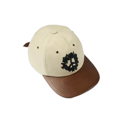 DENIM TEARS Peace Wreath Leather Brim Cap "Creme Brulee"